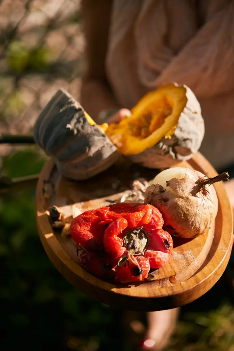 Fire-roasted red pepper, onion and squash on a wooden board