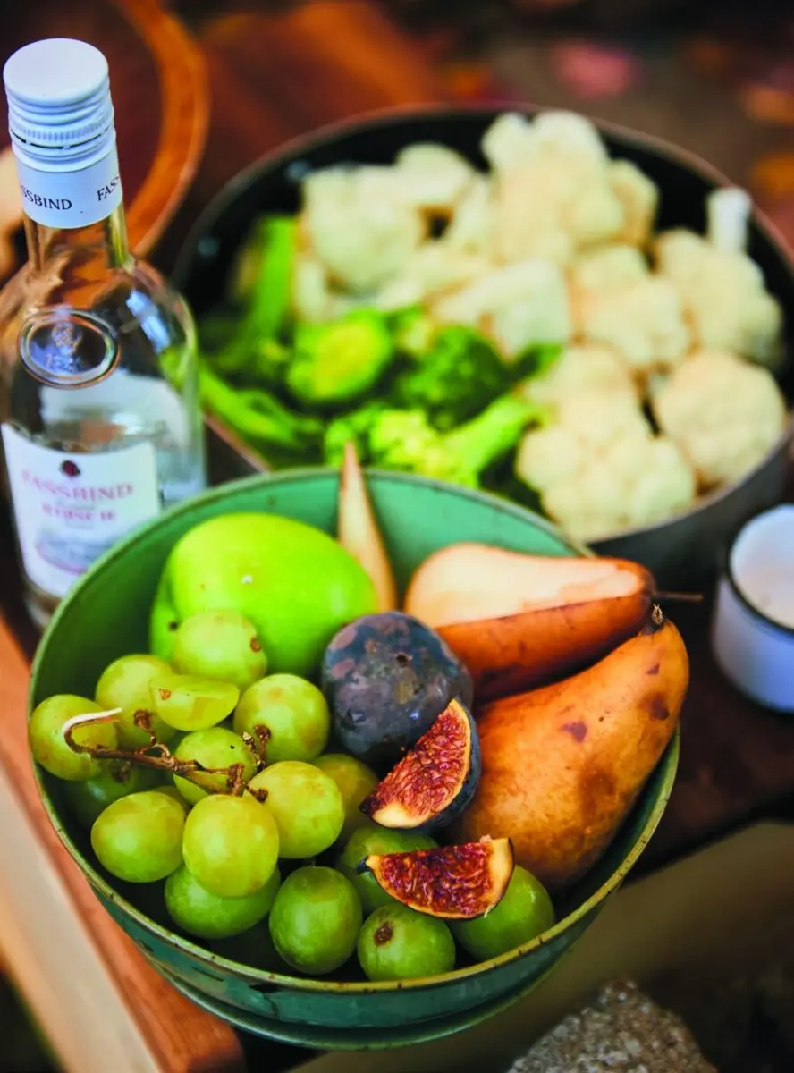 Campfire Cheese Fondue 2 Bowls of grapes, pears, figs, cauliflower and broccoli set out for campfire cheese fondue